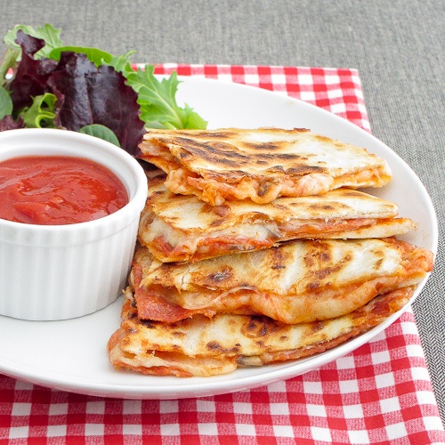 pizza quesadilla served with a side salad